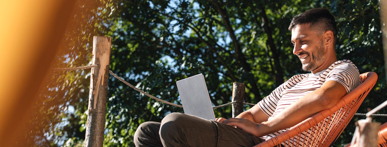 Man on laptop outdoors